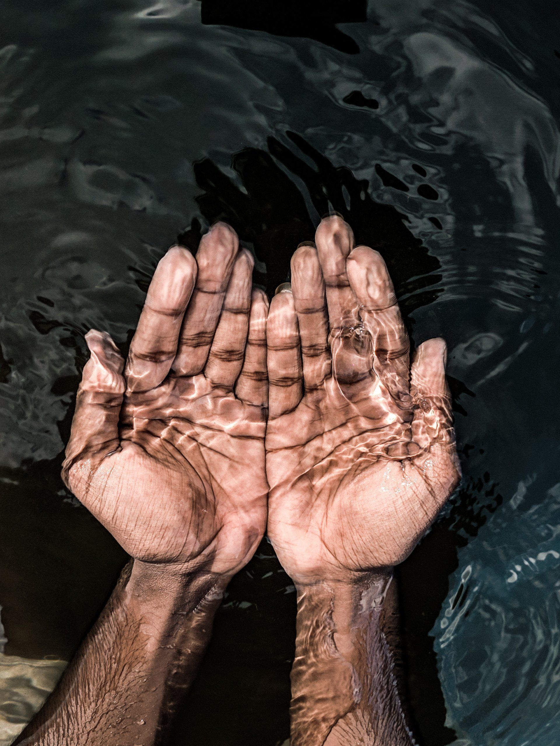 Cupped open hands holding water